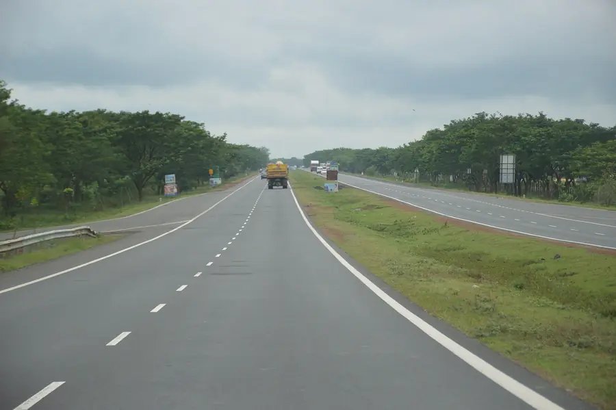 An open national highway at dawn, the kind of road our Chennai coaches run every day